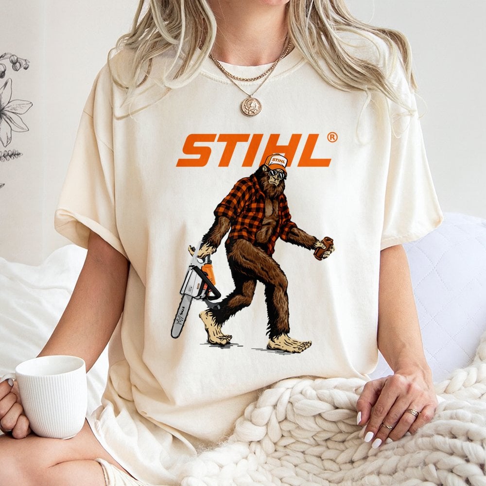 Bigfoot With Chainsaw Graphic T-Shirt | Retro Lumberjack Sasquatch Print | Premium 100% Cotton Tee | Gift for Woodsman and Ou