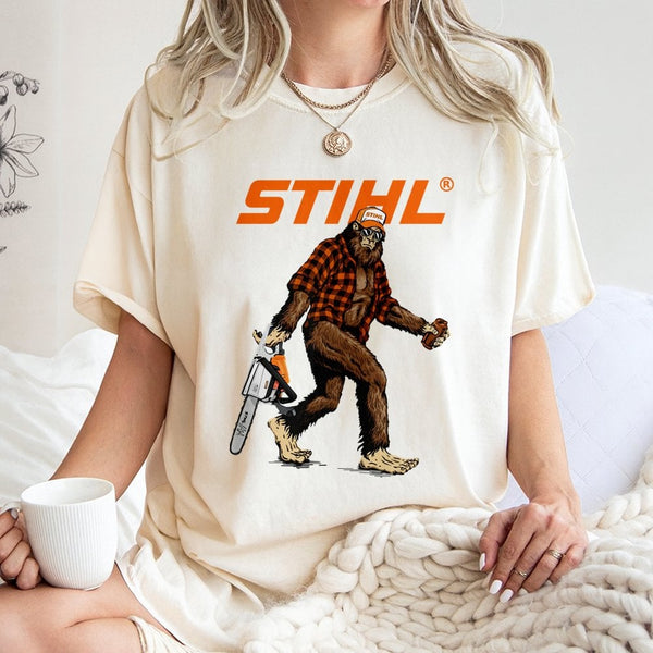 Bigfoot With Chainsaw Graphic T-Shirt | Retro Lumberjack Sasquatch Print | Premium 100% Cotton Tee | Gift for Woodsman and Ou